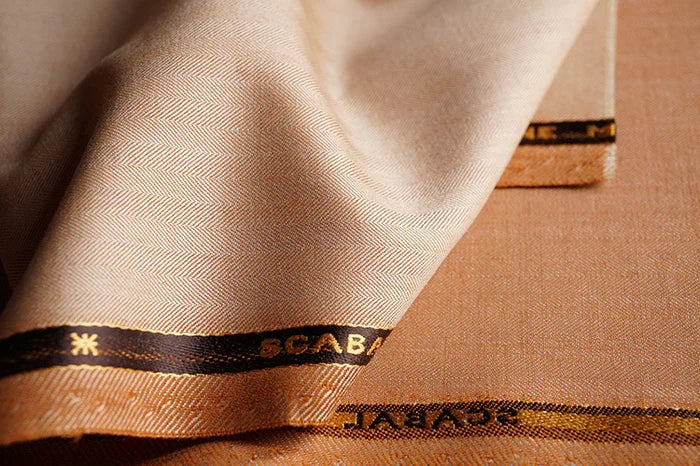 Lightweight beige herringbone cloth selected for summer tailoring