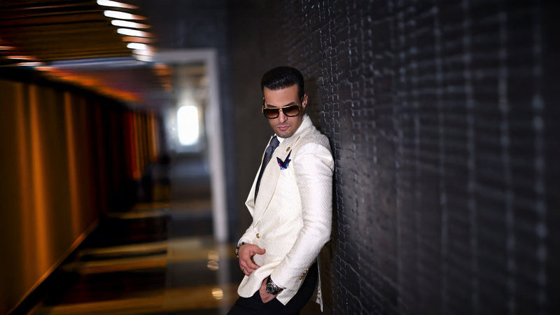 Mo Adass wearing a white dinner jacket inside Signature Bespoke