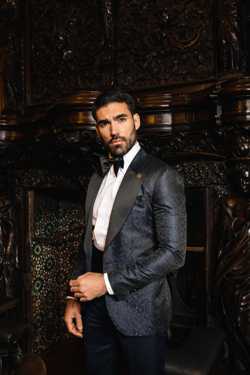 Close portrait of a man in a midnight blue dinner jacket and black bow tie