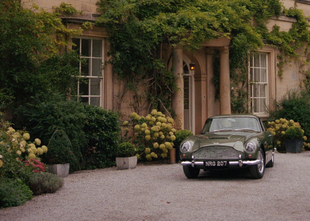 Classic Aston Martin outside a country house wedding venue