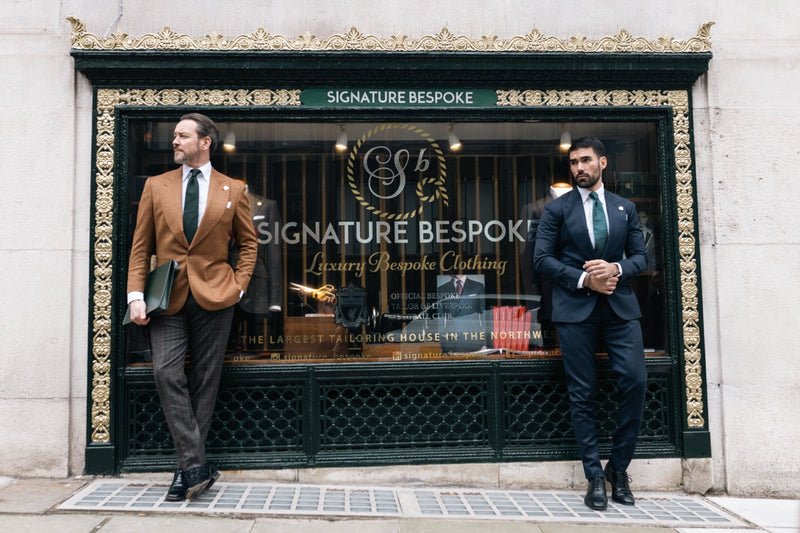 Two men wearing navy and brown bespoke tailoring