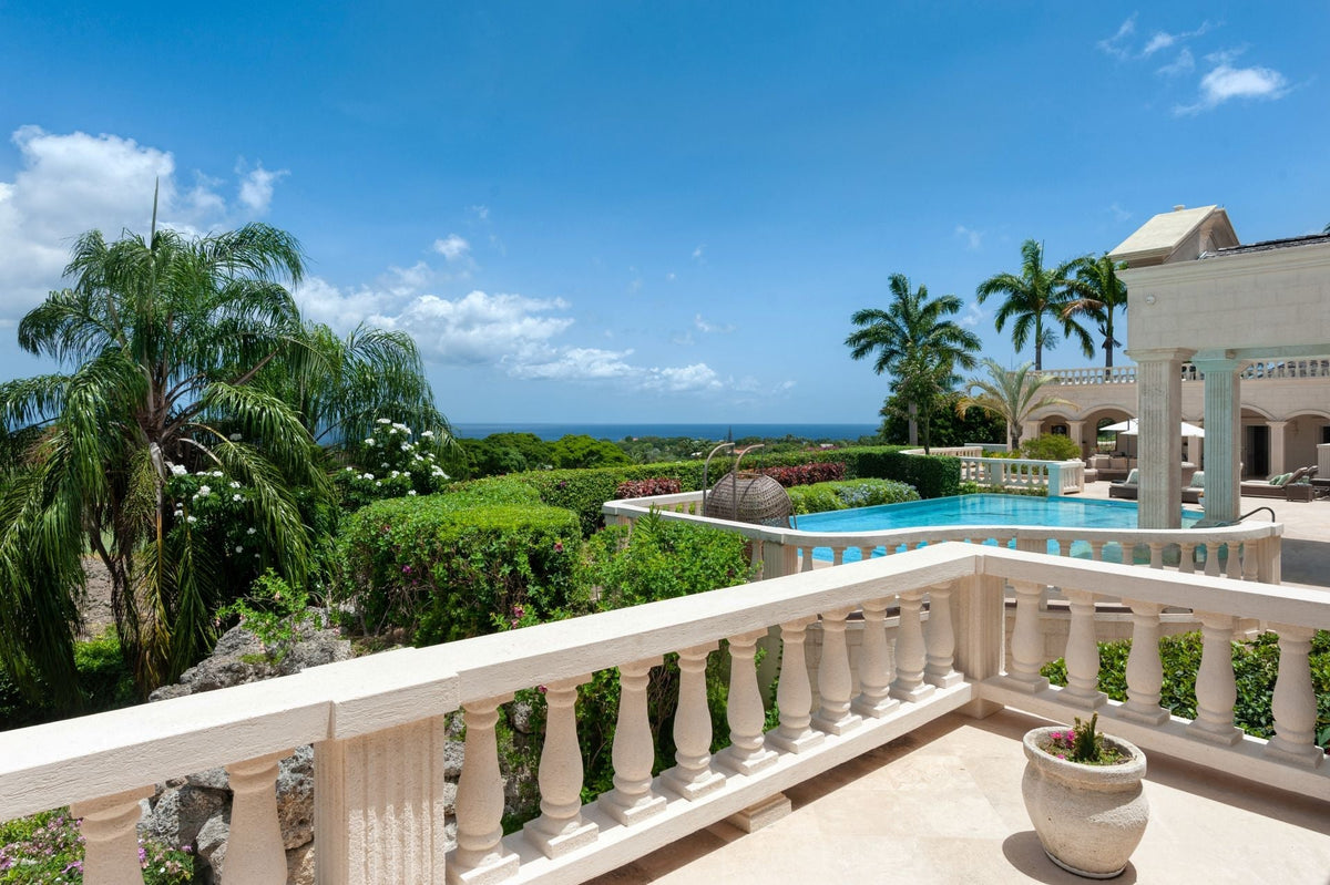 Private Caribbean estate overlooking the sea through palm trees