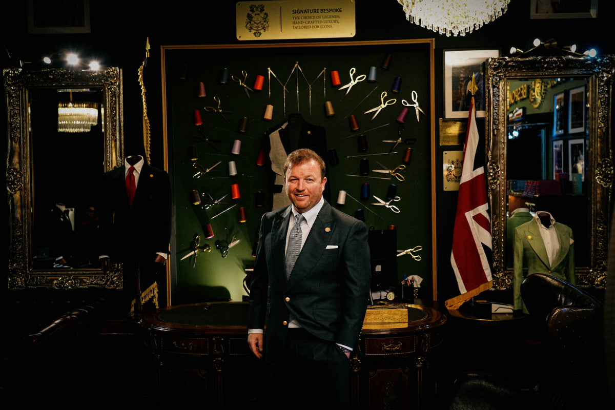 Man wearing a dark green bespoke suit in the Signature Bespoke Liverpool showroom