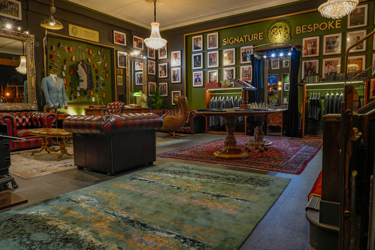 Interior of the Signature Bespoke Liverpool showroom with suits, tailoring displays and leather seating