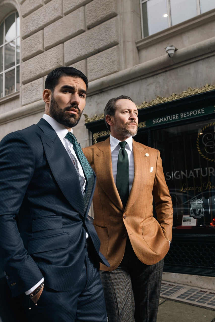 A client in burgundy bespoke tailoring arriving for a private appointment