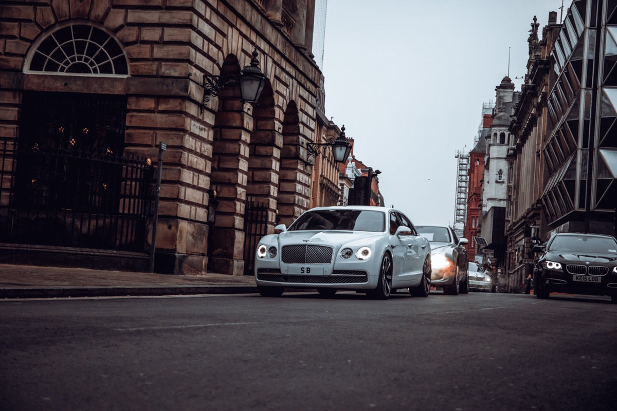 model stepping from car wearing bespoke suit editorial scene